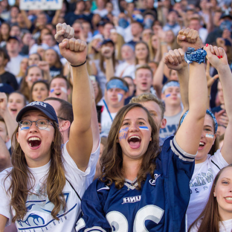 UNH fans cheering for their football team